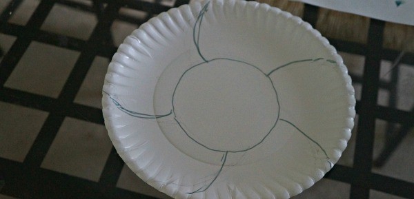 Making a paper plate Easter basket craft, prep the plate
