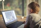 Kid using internet laptop computer